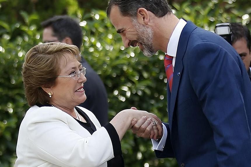 Spain's King Felipe (right) welcoming Chile's President Michelle Bachelet at Madrid's Zarzuela palace Oct 29, 2014.&nbsp;&nbsp;A Chilean judge jailed two retired colonels on Friday for torturing President Michelle Bachelet's father, who was arrested 
