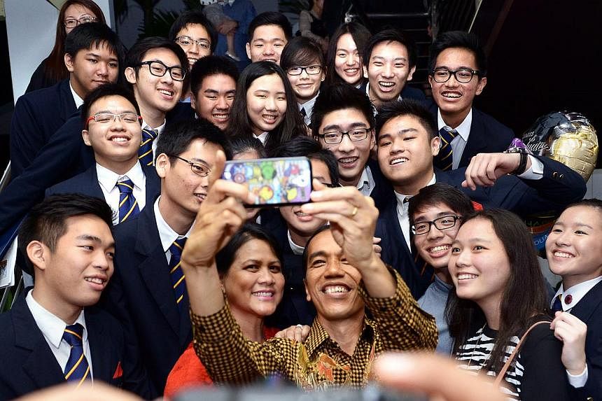 Indonesia President Joko Widodo and First Lady Iriana Widodo in a selfie with his son Kaesang Pangarep's (top right, with glasses) friends.&nbsp;-- ST PHOTO:&nbsp;LIM SIN THAI