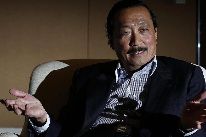 Malaysian billionaire Vincent Tan speaks to Reuters during an interview in Singapore Oct 29, 2014.&nbsp;Cardiff owner Tan said Wigan are run by a "racist chairman" who had hired a "racist manager" as fallout from the appointment of Malky Mackay as te