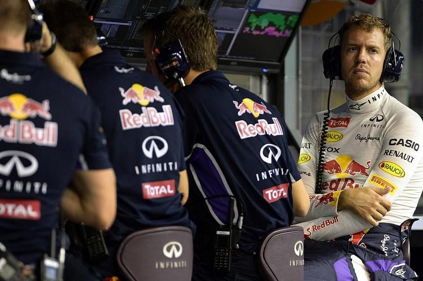 Sebastian Vettel listens to the race from the pit lane during a practice session at the Singapore Grand Prix, Sept 19 2014.&nbsp;Sebastian Vettel has no expectations of interfering with Mercedes' intra-team title battle in Sunday's Abu Dhabi Grand Pr