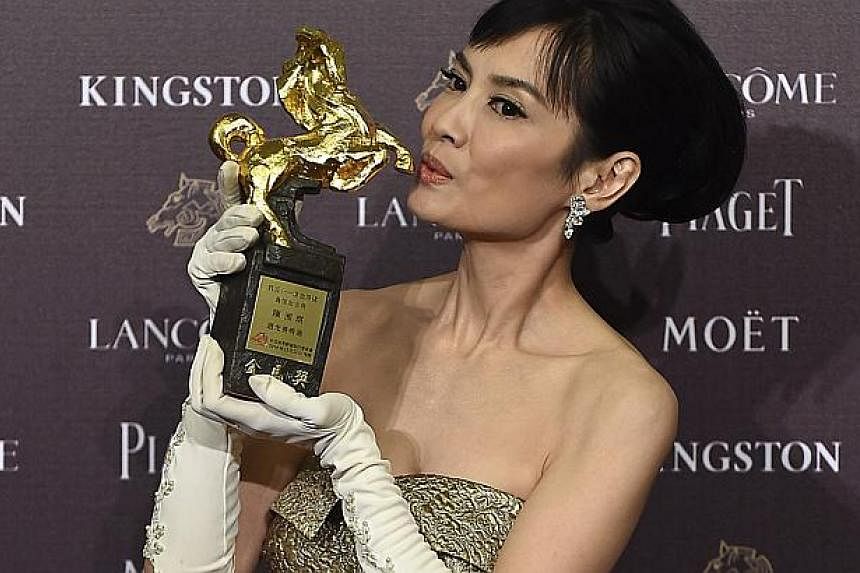 Taiwanese actress Chen Shiang-chyi celebrates winning the Best Leading Actress for "Exit" at the 51st Golden Horse Film Awards in Taipei Nov 22, 2014. -- PHOTO: REUTERS