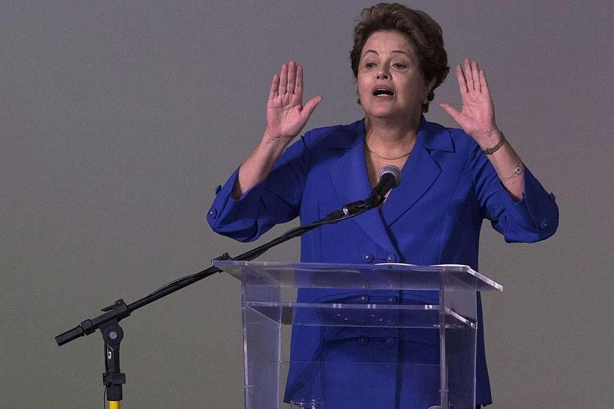 A month after winning re-election, Brazilian President Dilma Rousseff (above) is battling the toughest of starts to her second term with a huge corruption scandal at state-owned oil giant Petrobras threatening to engulf her government. -- PHOTO: REUT