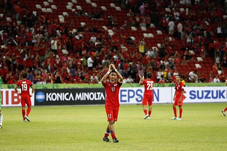 Singapore captain Shahril Ishak leads the team in thanking the fans after their 2-1 loss to Thailand in the AFF Suzuki Cup match at the National Stadium on Nov 23, 2014. -- ST PHOTO: KEVIN LIM