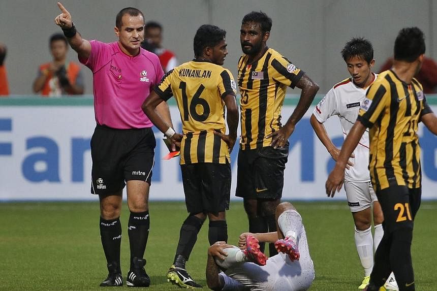 Malaysia's Gary Steven Robbat (No. 15, centre) is sent off by the referee during their AFF Suzuki Cup match against Myanmar at Jalan Besar Stadium on Nov 23, 2014. -- ST PHOTO: KEVIN LIM