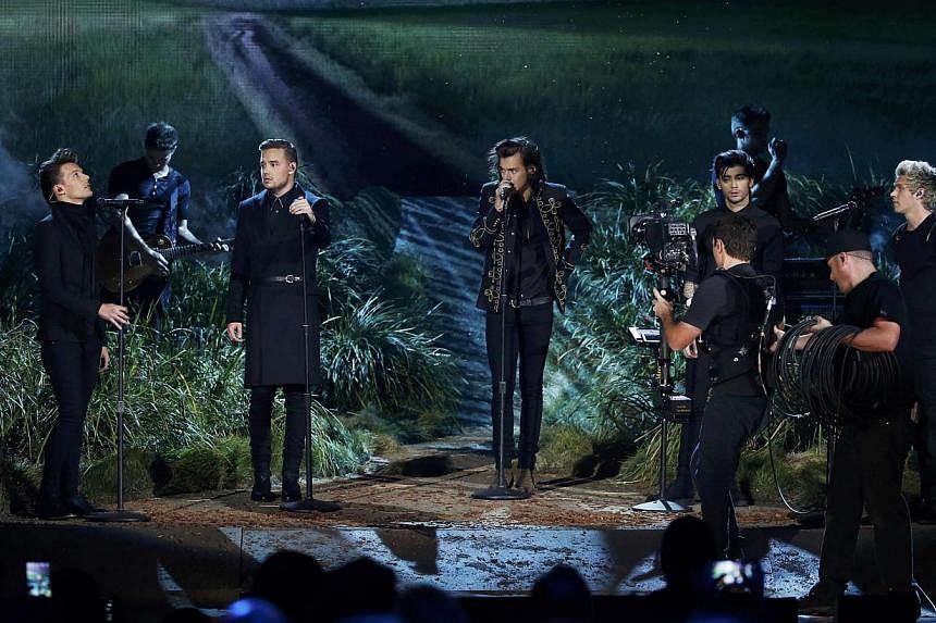 One Direction performs Night Changes on stage during the 42nd American Music Awards in Los Angeles, California on Nov 23, 2014. -- PHOTO: REUTERS