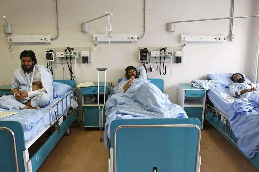 Men receive treatment at a military hospital in Kabul, after being wounded during a suicide attack at a volleyball match on Sunday in the Yahya Khail district of Paktika province, on Nov 24, 2014. Paktika provincial spokesman Mukhlis Afghan said in a