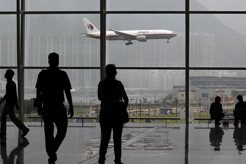A Malaysia Airlines Boeing 777 plane is seen from the departure hall at the Hong Kong International Airport, in this June 2, 2011 file photo.&nbsp;Malaysian flights currently fly through Iranian and Turkish airspace to reach destinations in Europe to
