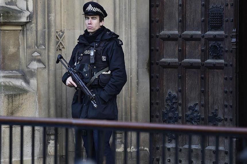 An armed police officer stands guard outside the Houses of Parliament in central London, on Nov 24, 2014.&nbsp;British police on Monday urged the public to be alert to potential terrorist activity as they said the threat of extremist attacks would la