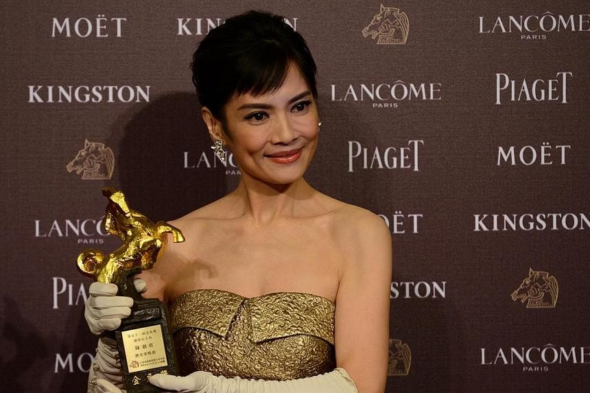 Taiwan actress Chen Shiang Chyi displays a trophy after winning the Best Leading Actress during the Golden Horse Film Awards in Taipei on Nov 22, 2014. -- PHOTO: AFP