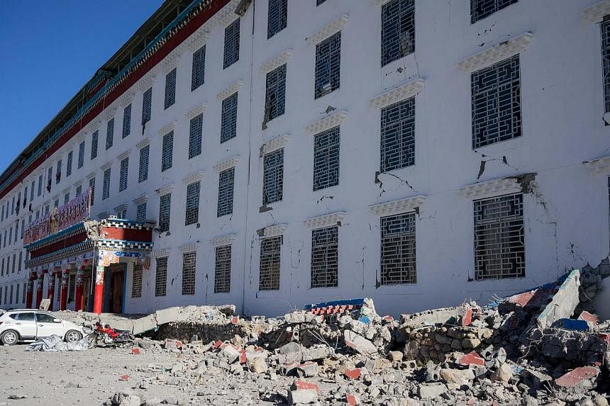 IN JAPAN: Damaged gravestones after a 6.7-magnitude earthquake hit Hakuba, some 300km north-west of Tokyo, in Nagano prefecture. At least 39 people were injured in the quake that struck last Saturday night. IN CHINA: A village school in Kangding Coun