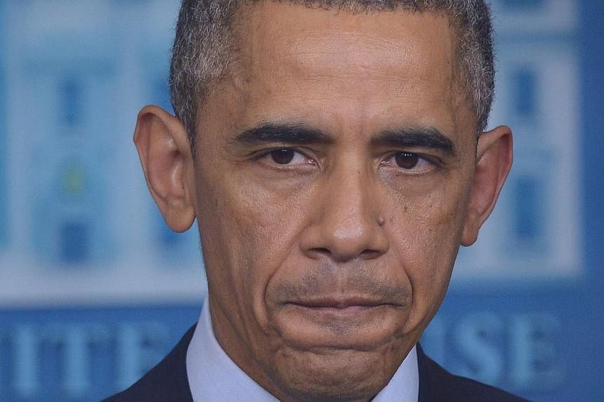 US President Barack Obama speaks following the announcement of the decision in the case of Ferguson police officer Darren Wilson for the shooting death of teenager Michael Brown. -- PHOTO: AFP