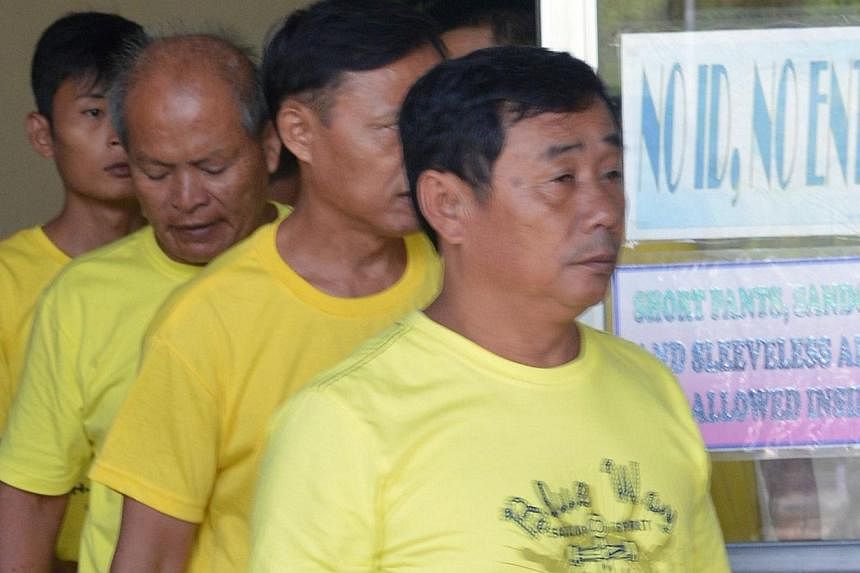 A group of Chinese fishermen leave a court in Puerto Princesa, Palawan island on Nov 24, 2014, after they were found guilty of poaching.&nbsp;China said on Tuesday that the fines imposed by a court in the Philippines on nine Chinese fishermen for cat