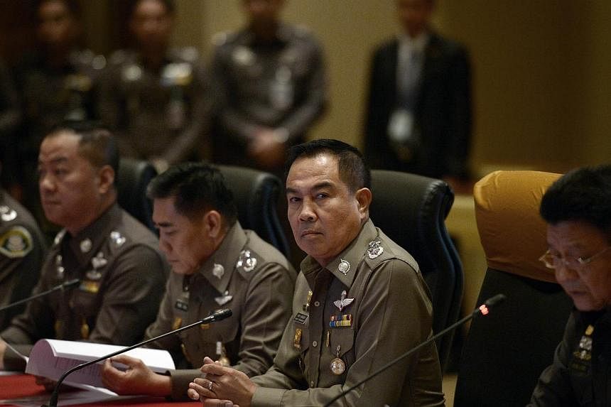 Thai national police chief Somyot Poompanmoung (centre) attends a press conference at the Royal Thai Police headquarters in Bangkok on Nov 25, 2014.&nbsp;Thai police said Tuesday they have charged a third high-ranking officer with lese majeste and al