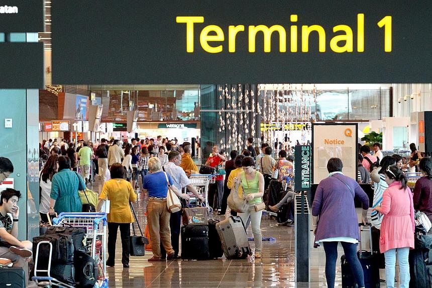 Passengers at Changi Airport Terminal 1. -- PHOTO: ST FILE