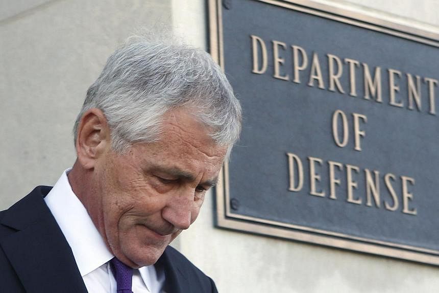 US Secretary of Defense Chuck Hagel walks out to welcome New Zealand's Minister of Defence Gerry Brownlee at the Pentagon in Washington on Nov 24, 2014. -- PHOTO: REUTERS