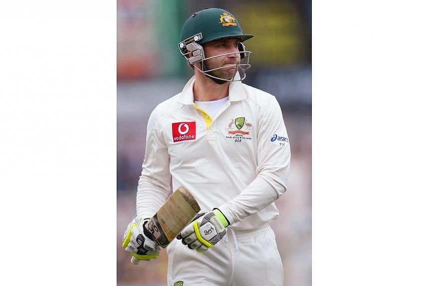 Australian batsman Phil Hughes reacting after he was dismissed by Sri Lanka on the first day of the first cricket Test match in Hobart on Dec 14, 2012.&nbsp;Australian batsman Phil Hughes was in critical condition following emergency surgery on Tuesd