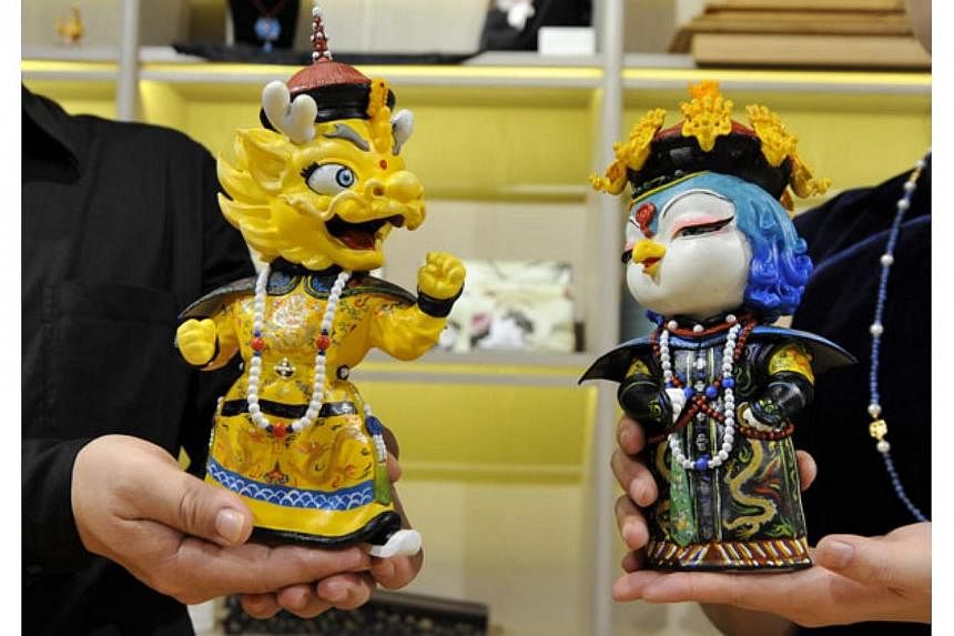 The 600-year-old Forbidden City is going cuddly and tapping into e-commerce to appeal to the younger generation with two new mascots: a dragon named Zhuangzhuang (left) and a phoenix named Meimei. -- PHOTO: CHINA DAILY/ASIA NEWS NETWORK