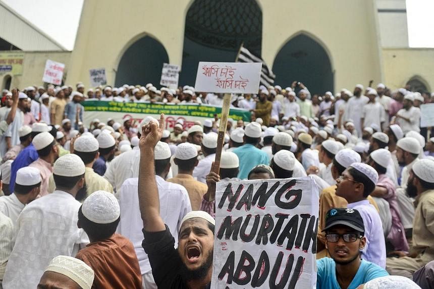 Activists of a Bangladeshi Islamic political group protest against Abdul Latif Siddique, the then telecommunications minister, after his criticism of the Muslim pilgrimage of Hajj, in Dhaka on Oct 2, 2012.&nbsp;Mr Siddique surrendered to Bangladesh p