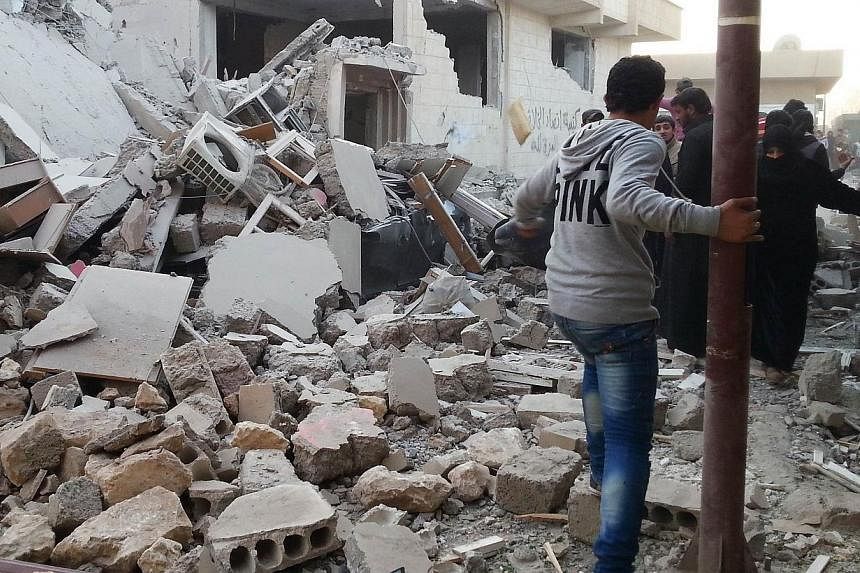 Syrian regime air raids on Raqa city, which the Islamic State in Iraq and Syria extremist group has proclaimed as its capital, killed at least 63 people, more than half of them civilians&nbsp;on Tuesday, a monitoring group said. -- PHOTO: AFP