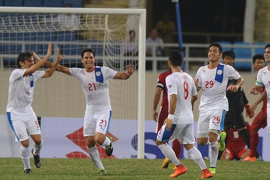 Philippines' Martin Markus Pineda Steuble (#21) and his teammates celebrate after he scored the third goal against Indonesia during an AFF Suzuki 2014 Cup match at Hanoi's My Dinh stadium on Nov 25, 2014.&nbsp;The Philippines national football team b