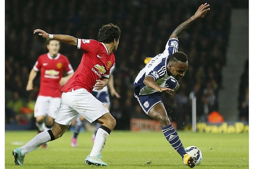 Saido Berahino (right) of West Bromwich Albion is tackled by Rafael of Manchester United during their English Premier League soccer match at The Hawthorns in West Bromwich on Oct 20, 2014.&nbsp;Rising English football star Saido Berahino&nbsp;has bee