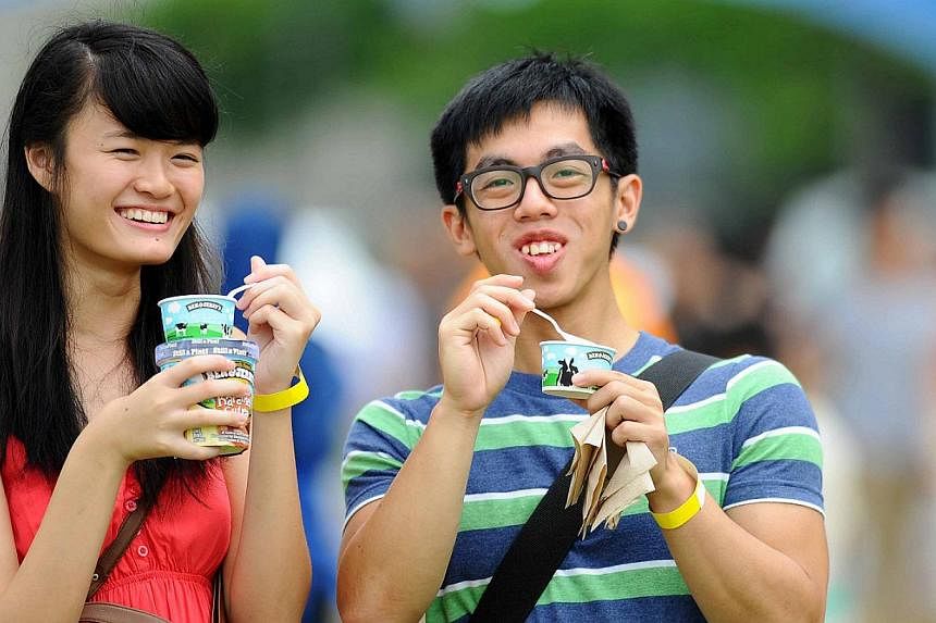 A couple enjoys ice cream from Ben &amp; Jerry’s at Chunkfest 2014, a much-loved outdoor festival organised by the ice cream-maker. -- PHOTO: BEN &amp; JERRY'S SINGAPORE&nbsp;