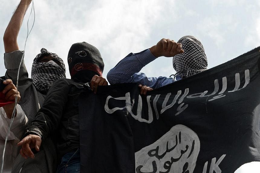 Kashmiri demonstrators on July 18, 2014, holding up an ISIS flag during a demonstration against Israeli military operations in Gaza in downtown Srinagar, India. With the ISIS seeking to redraw the map of the region, and willing to take the help of re