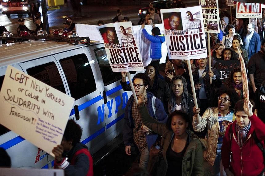 Protesters shout slogans against the law as they march on the street during a rally in New York on Nov 24, 2014, after the grand jury reached a decision in the death of 18-year-old Michael Brown in Ferguson, Missouri. -- PHOTO: REUTERS