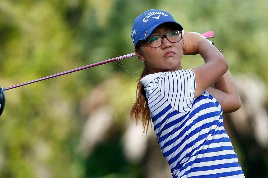 Lydia Ko of New Zealand plays a shot on the 17th hole during the final round of the CME Group Tour Championship at Tiburon Golf Club on Nov 23, 2014 in Naples, Florida. -- PHOTO: AFP
