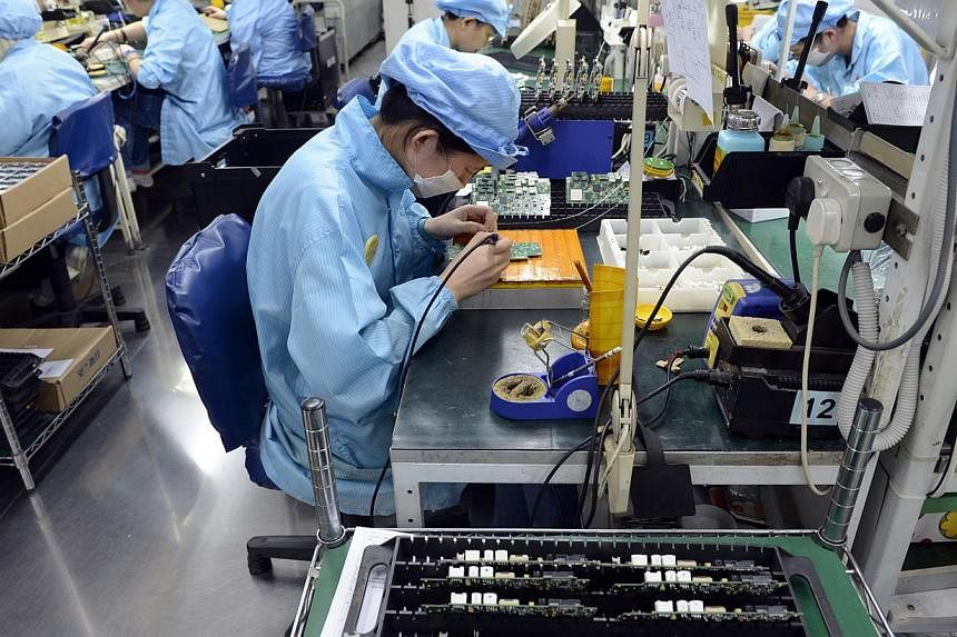 The electronics cluster, which makes up a third of manufacturing output, contracted 6.1 per cent in October over the same month last year. -- ST PHOTO: DESMOND FOO