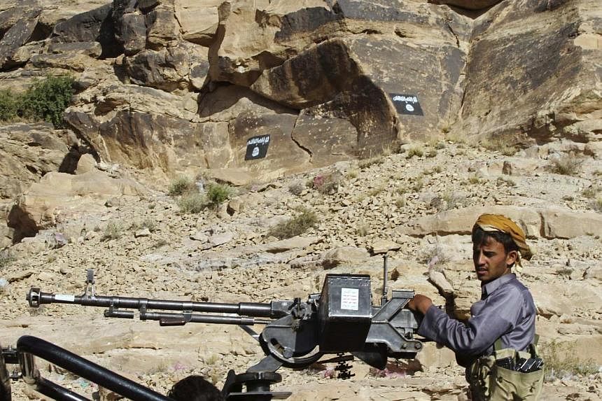 A Shi'ite Houthi manning a weapon on the back of a patrol truck travelling on a road in Almnash, the main stronghold of Ansar al-Sharia, the local wing of Al-Qaeda, on Nov 22, 2014. -- PHOTO: REUTERS