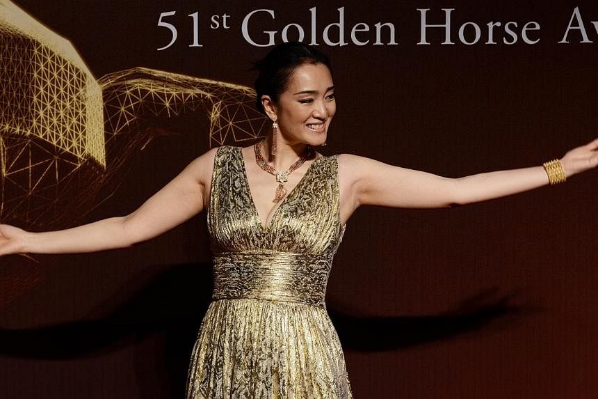 Chinese actress Gong Li arrives ahead of the Golden Horse Film Awards in Taipei on Nov 22, 2014.&nbsp;Gong Li has come under fire after apparently vowing not to take part in the "unprofessional" Golden Horse Awards any more. -- PHOTO: AFP