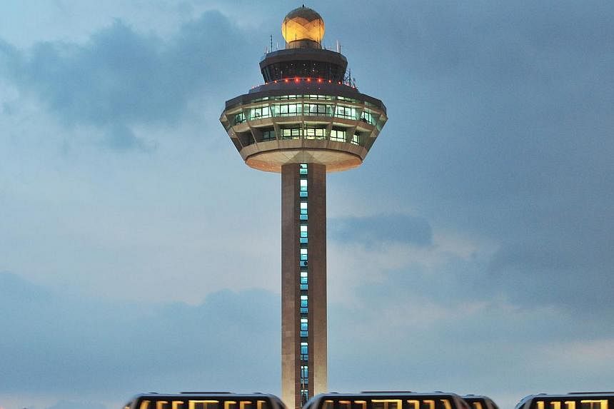 The Changi Airport control tower. This year, Changi Airport handled 44.58 million passengers, a 1 per cent growth over the same period last year. -- PHOTO: ST FILE