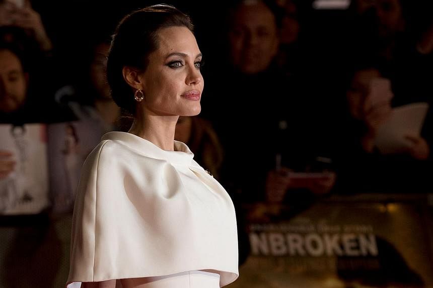 Angelina Jolie poses on the red carpet for the UK premiere of the film Unbroken at Leicester Square in London on Nov 25, 2014. -- PHOTO: AFP