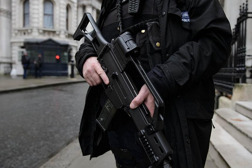 An armed police officer stands guard in Downing Street, central London, on Nov 26, 2014. British Muslim rights groups and ordinary faithful said they felt singled out by a tough new anti-terror law unveiled on Wednesday, labelling the planned legisla