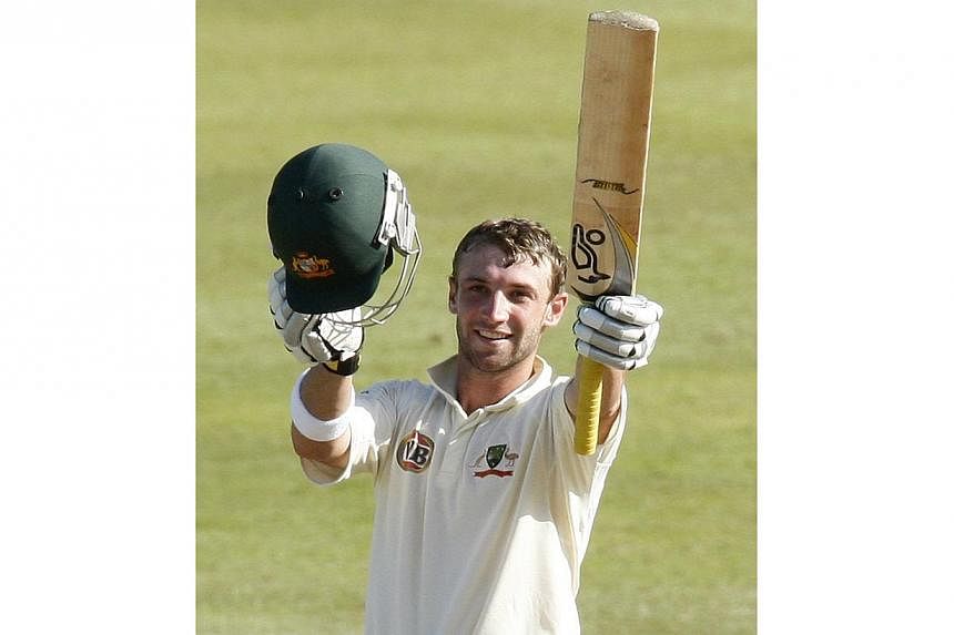 Australian batsman Phillip Hughes remained in a critical condition on Wednesday after surgery to relieve pressure on his brain, as players rallied around bowler Sean Abbott, whose ball inflicted the damage. -- PHOTO: REUTERS