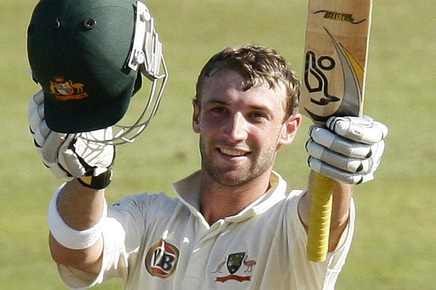 Australia's Phil Hughes celebrates his century during the third day of the second cricket test match against South Africa in Durban in this March 8, 2009 file photo.&nbsp;The manufacturer of the helmet worn by Phil Hughes said Tuesday he was not wear