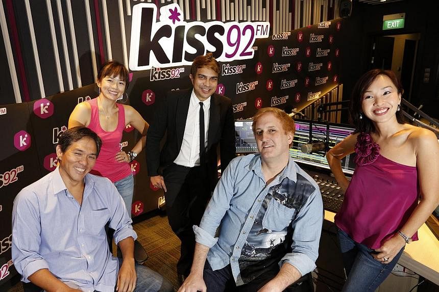 SPH Unionwork's KISS 92 DJs, (from left to right) Arnold Gay, Melody Chen, John Klass, Jason Johnson, and Maddy Barber pose for a photograph in the KISS 92 radio studio. -- PHOTO: ST FILE