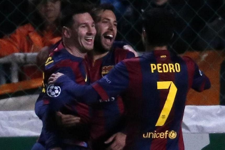 Barcelona's Argentinian forward Lionel Messi (left) celebrates with his teammates after scoring a goal during their UEFA Champions League football match against Apeol at the Neo GSP Stadium in the Cypriot capital, Nicosia, on Nov 25, 2014. -- PHOTO: 