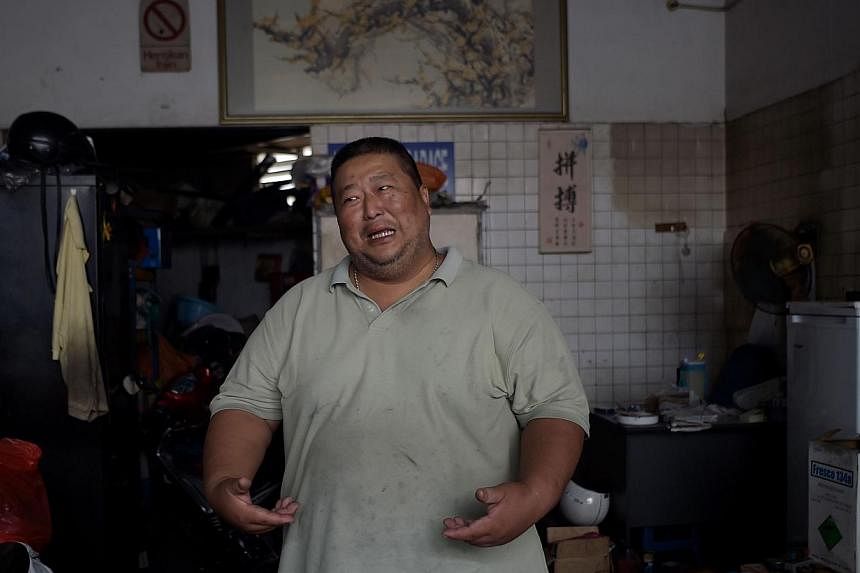 In this picture taken on Sept 8, 2014, Wong Siew Hong, a diabetic and automotive mechanic gestures while talking about his weight at his garage in Kuala Lumpur. Bad eating habits and unhealthy lifestyles have helped Malaysia earn the not-so-flatterin