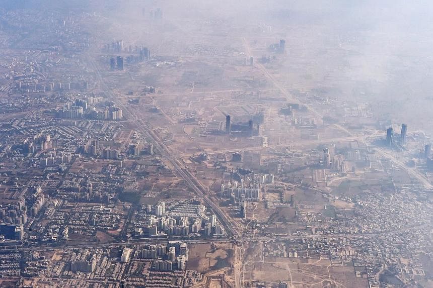 In this photograph taken on Nov 25, 2014, smog envelops buildings on the outskirts of the Indian capital New Delhi.&nbsp;India's environment court has slammed the government over the capital's horrendous air pollution, which it said was "getting wors
