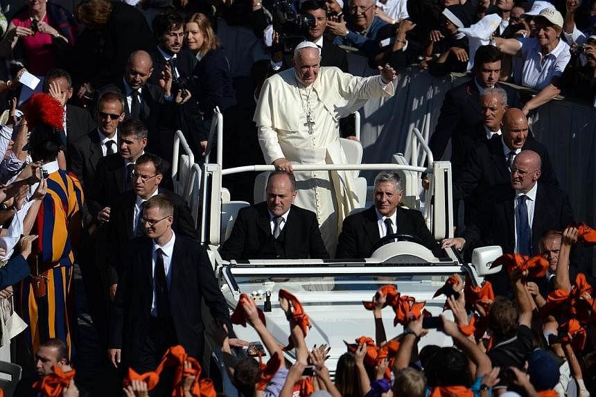 Pope Francis greets the crowd from the popemobile after a papal mass for the beatification of Paul VI, who died in 1978, and the end of Vatican's synod on the family at St Peter's square on Oct 19, 2014 at the Vatican.&nbsp;The Philippines will custo