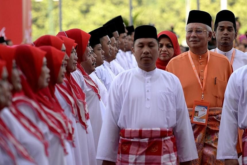 Malaysian Prime Minister Najib Razak (centre) inspects a ceremonial guard of honour during the annual congress of his ruling party, the United Malays National Organisation(UMNO) in Kuala Lumpur on Nov 27, 2014.&nbsp;Malaysia's Prime Minister Najib Ra