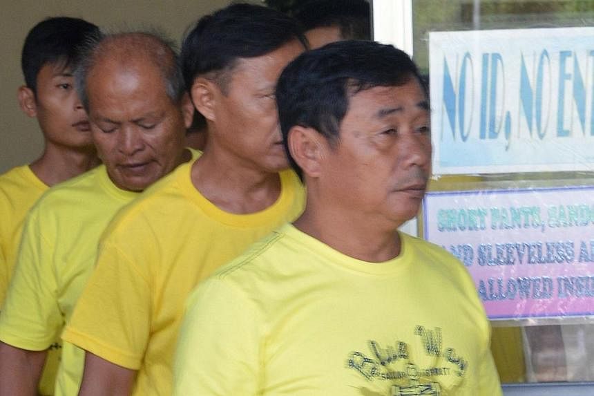 A group of Chinese fishermen leave a court in Puerto Princesa, Palawan island on Nov 24, 2014, after they were found guilty of poaching.&nbsp;Nine Chinese fishermen convicted this week of poaching by a Philippine court will be released and deported o