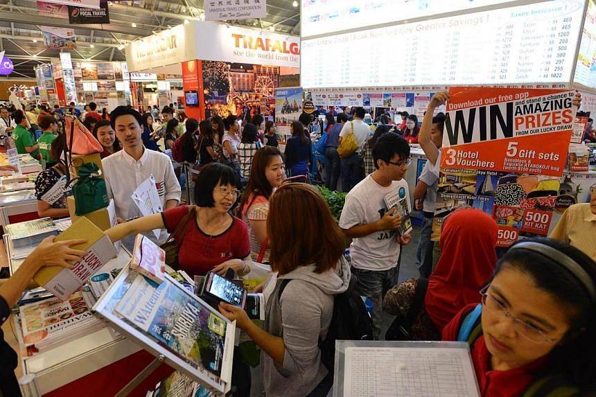 People at the Natas Holidays travel fair held in August 2014 at the Singapore Expo.&nbsp;Natas said on Thursday that it will waive the entrance frees to next year's fair, in line with Singapore's 50th birthday. -- PHOTO: ST FILE