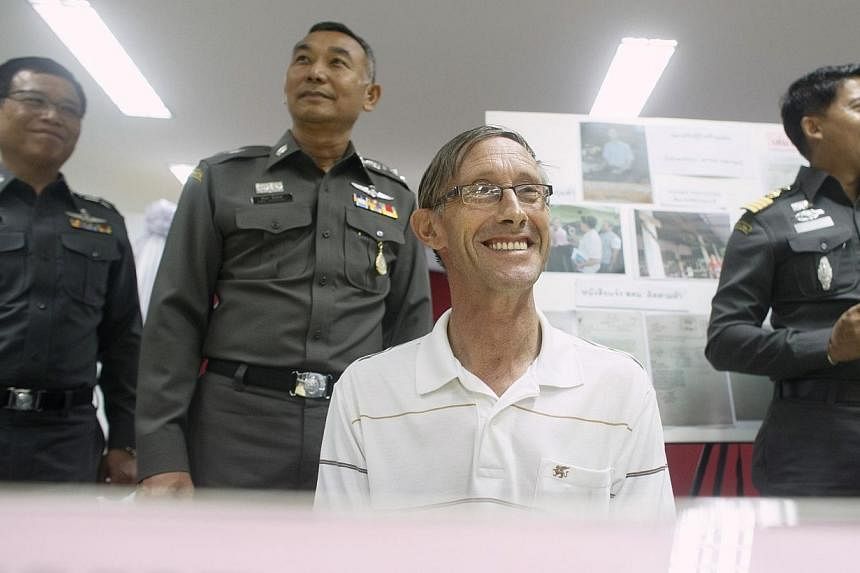 Robert David Hastings (centre), 61, from Britain, smiles during a news conference at the Immigration Detention Center in Bangkok on Nov 26, 2014.&nbsp;A British man wanted by British police for a string of paedophile offences has been arrested at a s