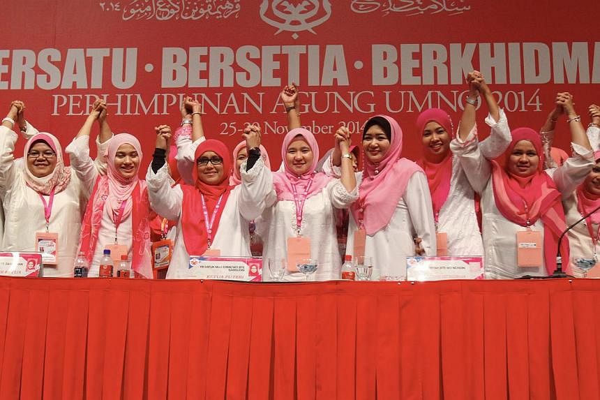 Puteri Umno chief Mas Ermieyati Samsudin (fourth from left) with committee members during the Umno women's wing's general assembly on Nov 26, 2014. Puteri Umno has set up its own "cyber commando" unit in defence of the party, religion and race. -- PH