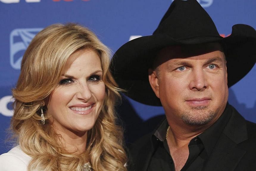Country music star Garth Brooks (above, with wife Trisha Yearwood) cancelled scheduled media appearances this week, saying it would be in poor taste to promote his comeback album during national protests after a grand jury did not indict a white poli
