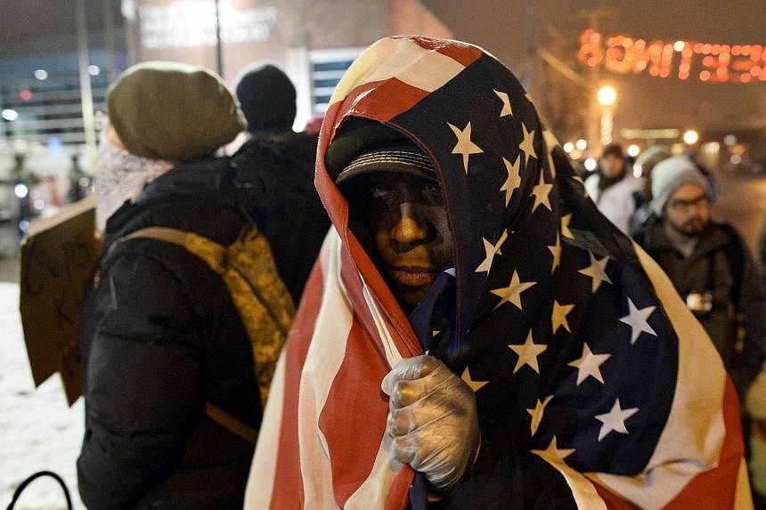 Protesters shout slogans at an intersection in Ferguson, Missouri, on Nov 26, 2014. -- PHOTO: AFP