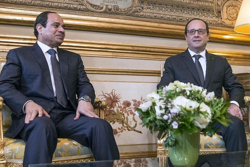 French President Francois Hollande (right) meets his Egyptian counterpart Abdel Fattah al-Sisi at the Elysee presidential palace in Paris on Nov 26, 2014. Sisi began a two-day trip to France, the second leg of a first European tour aimed at bringing 